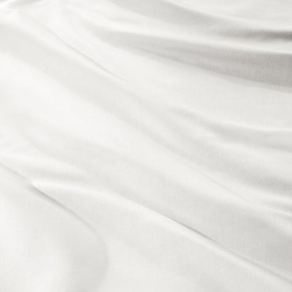 A close-up of draped sateen fabric with soft folds and a smooth texture.