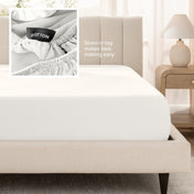 A fitted bed sheet shown on a bed. Text on the image says the sewn-in tag makes bed-making easy.