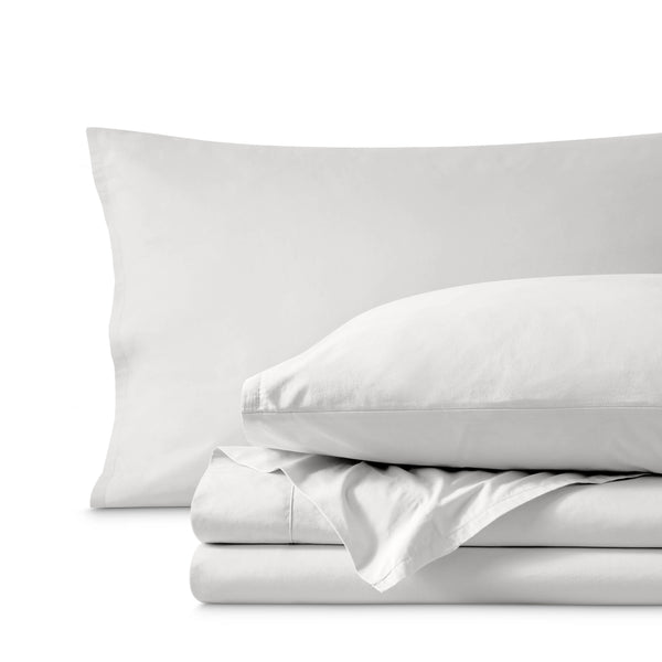 Percale bedding set including pillowcases and folded sheets arranged on a clean white background