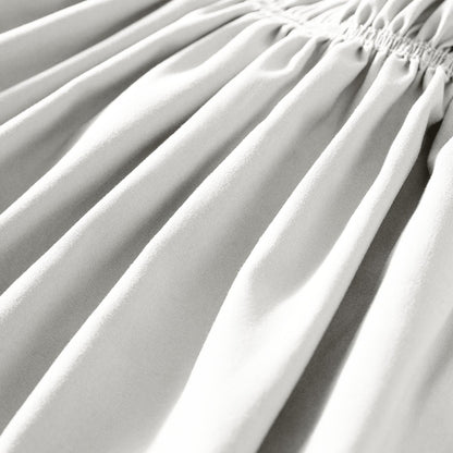 Close-up of polyester bed skirt fabric with a focus on texture and folds.