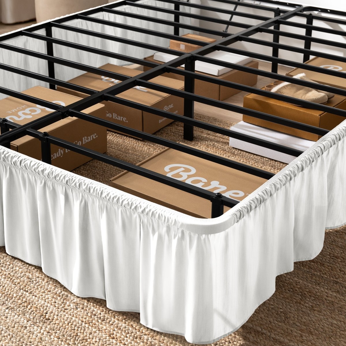 Bed frame with bed skirt and Bare Home boxes underneath.