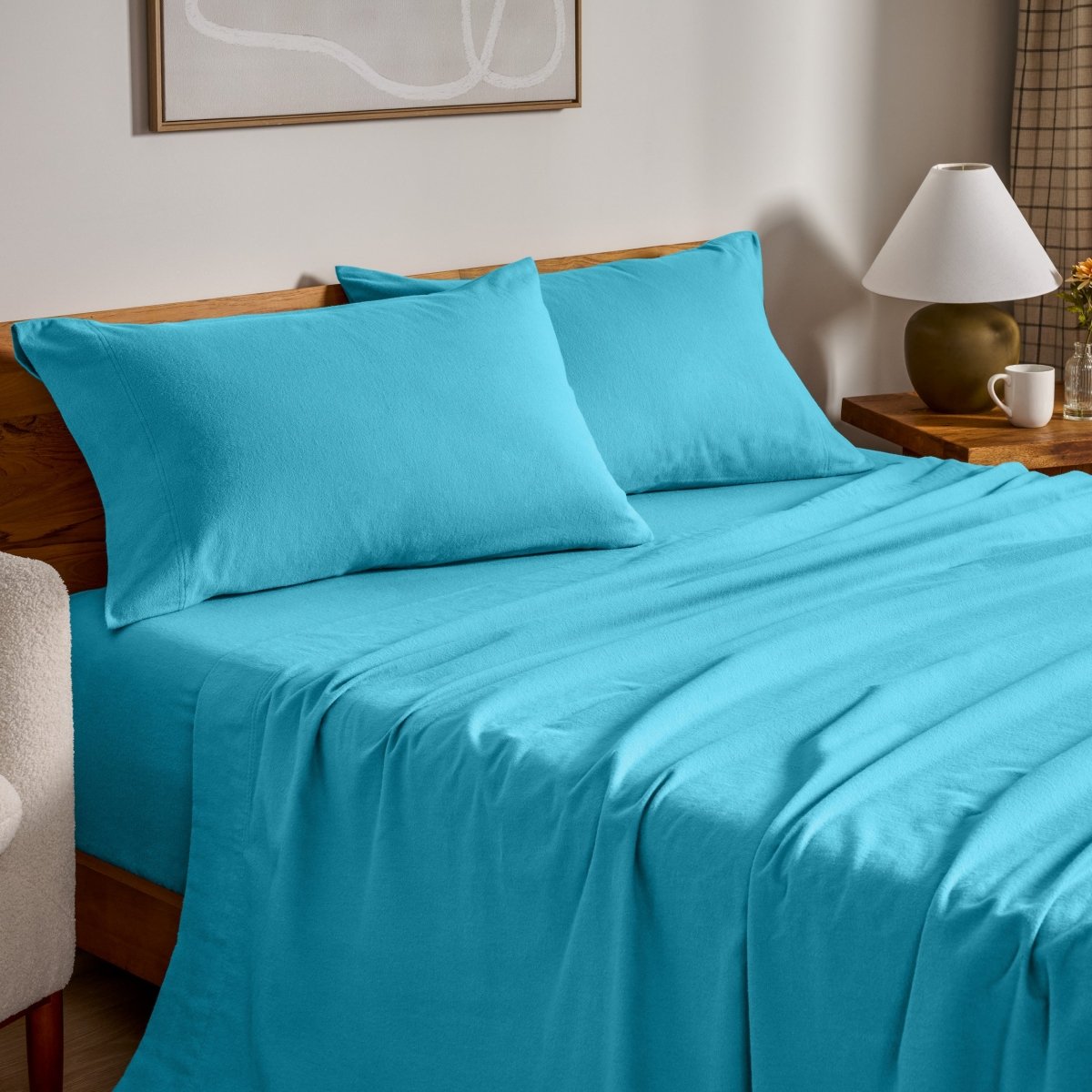 Flannel bed sheets and pillowcases on a bed in a bedroom setting.
