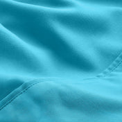 A close-up of microfiber fabric with soft folds and a visible stitched seam.