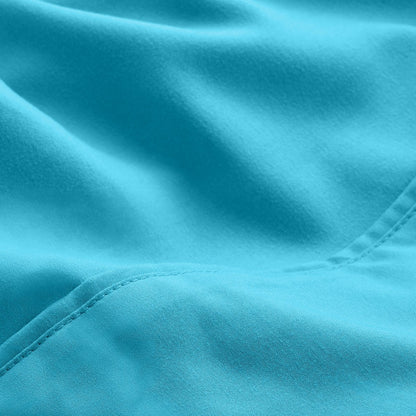 A close-up of microfiber fabric with soft folds and a visible stitched seam.