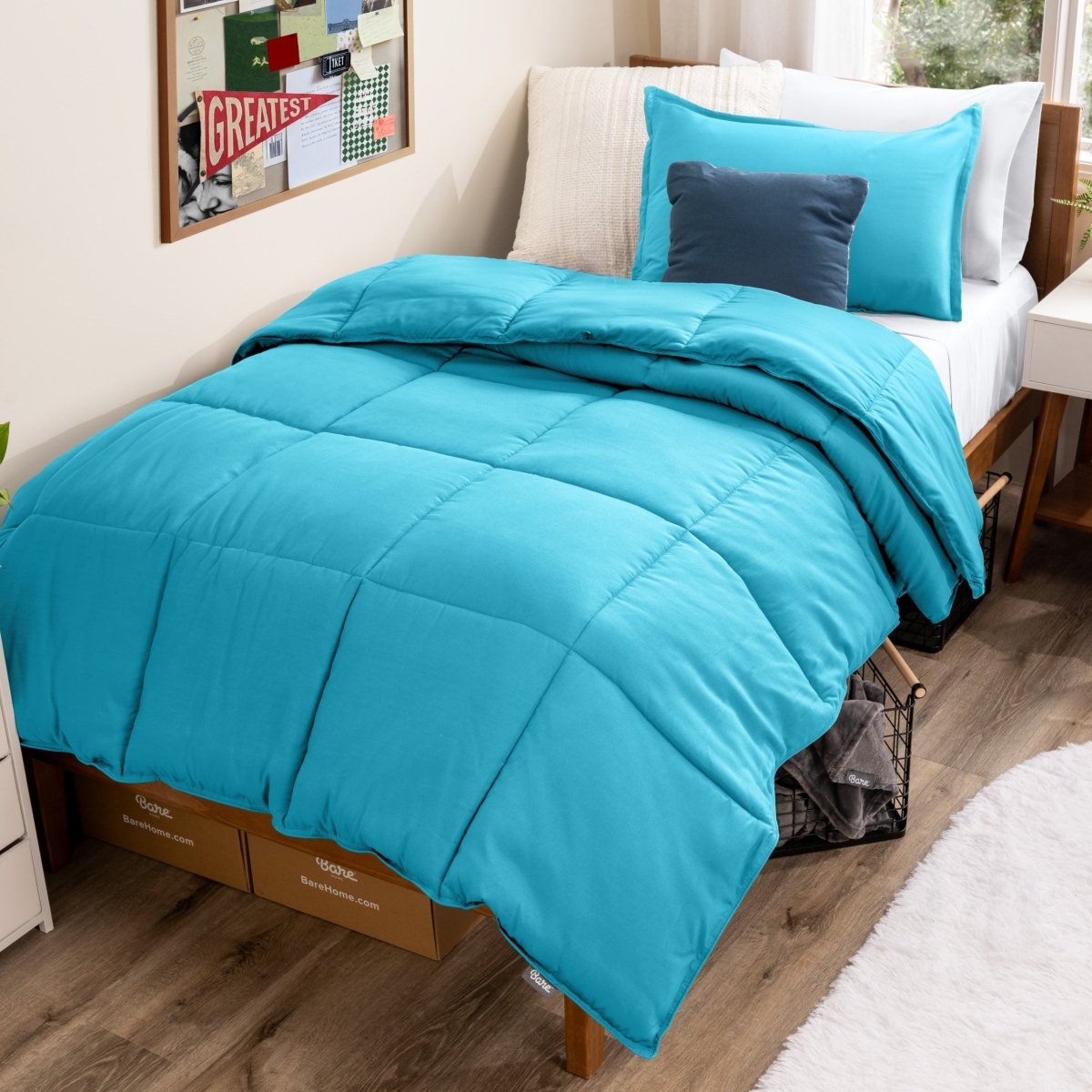 Bed with comforter and pillows in a dorm room