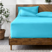 A bed with a fitted sheet and matching pillowcases