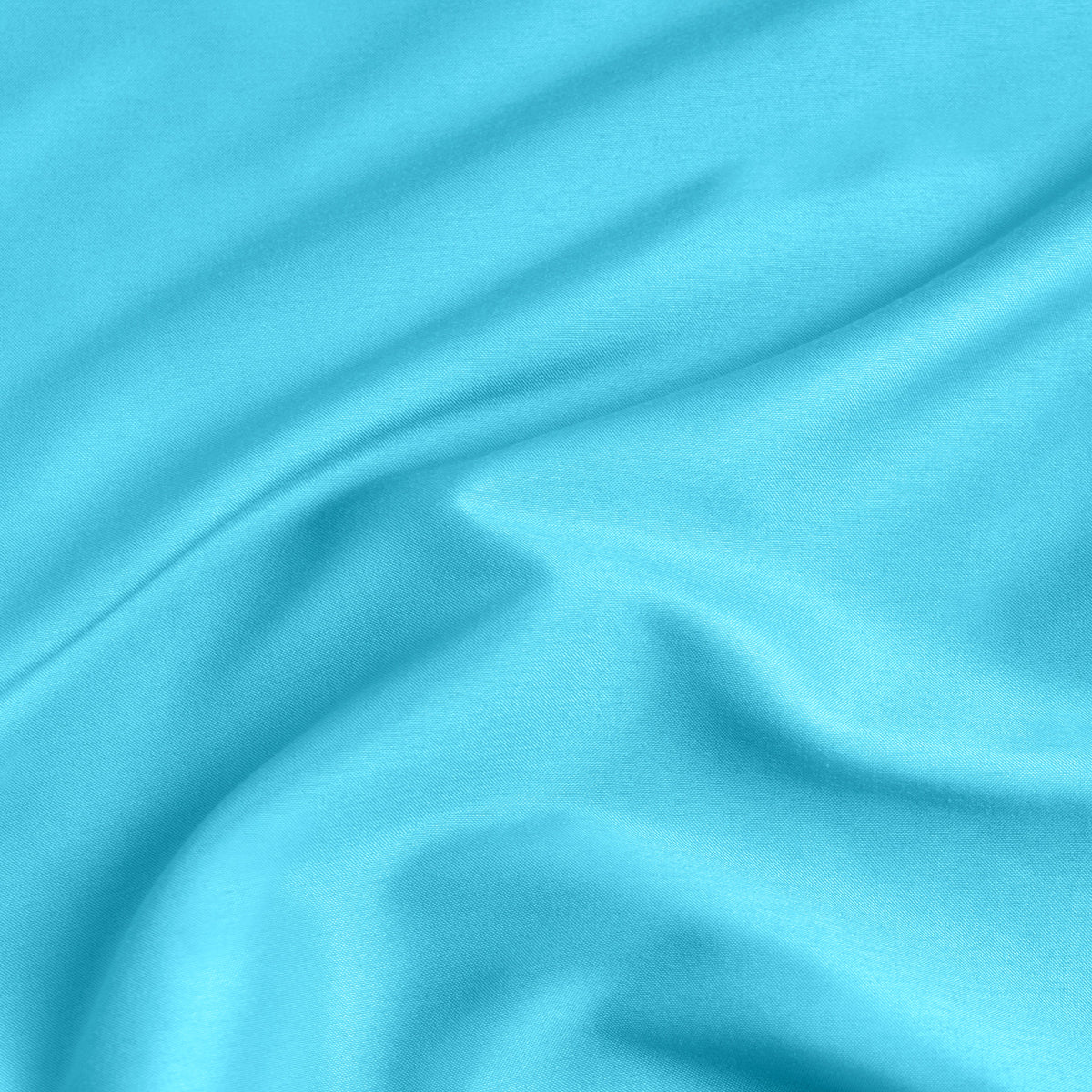 A close-up of a fitted sheet with a label printed with the word 'BOTTOM' in white.