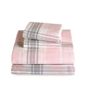 Stack of flannel sheets and pillowcases on a white background