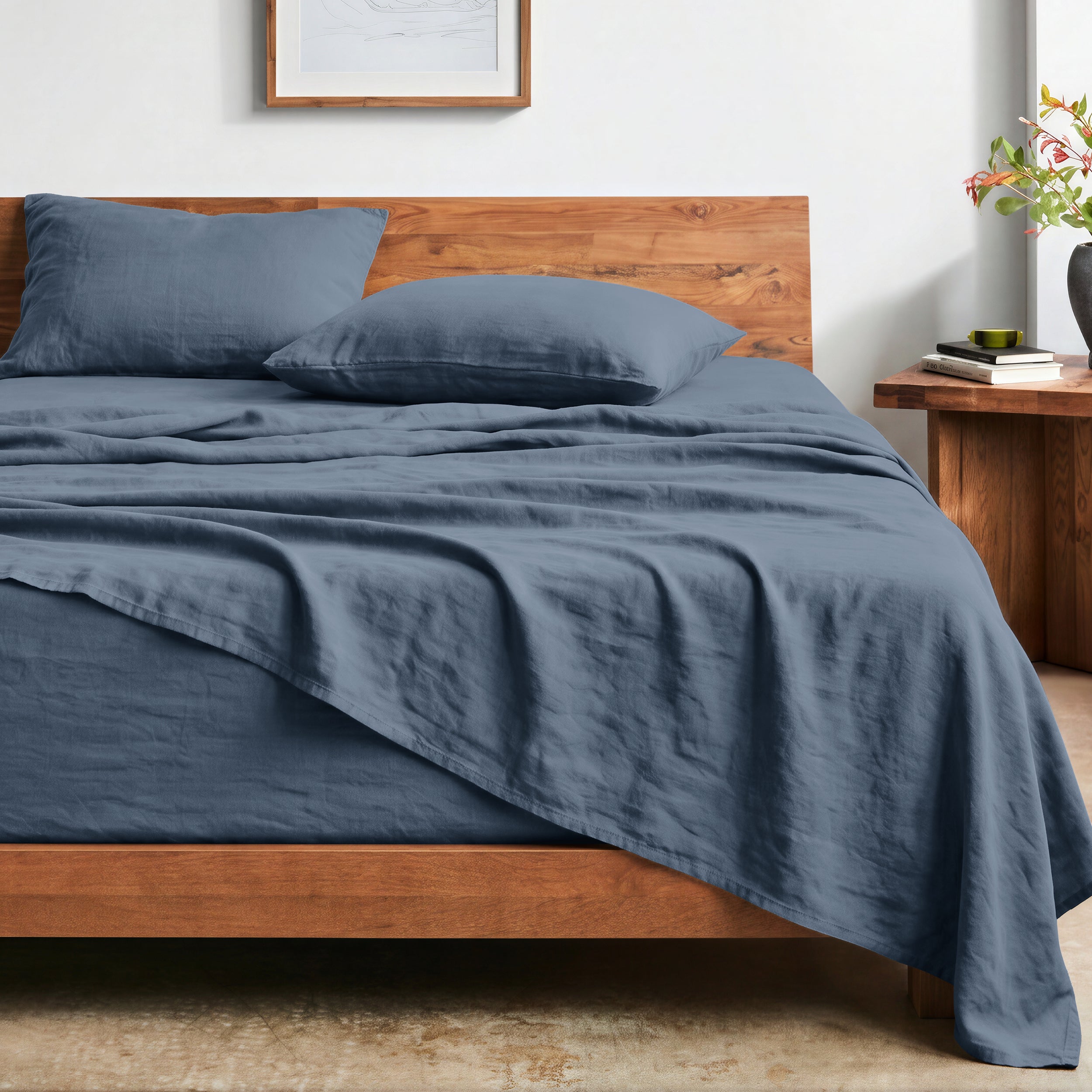 Bed with washed sheets and wooden headboard in a bedroom setting