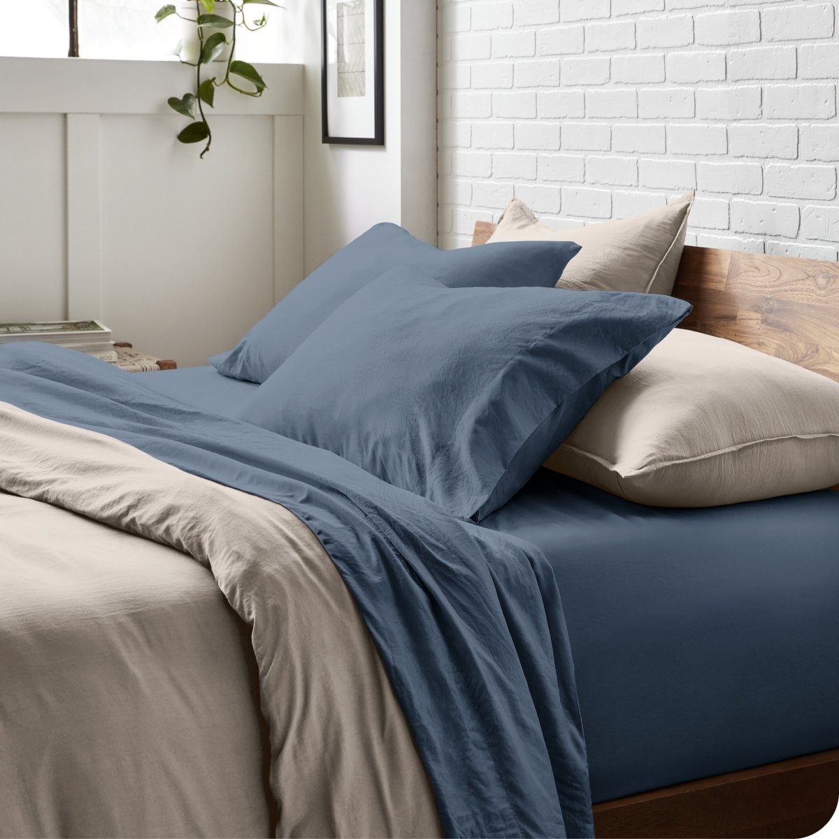Modern bedroom with washed sheets and duvet cover on a bed