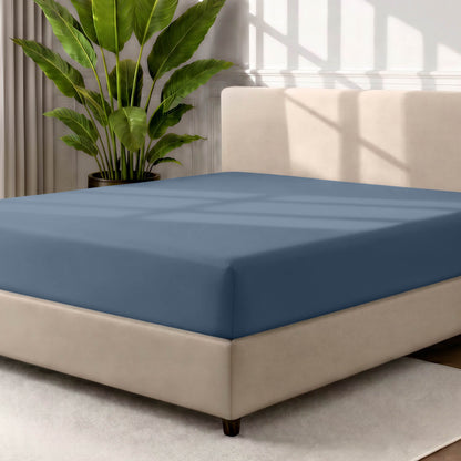 Ultra soft fitted sheet on a mattress with the sun shining into the bedroom