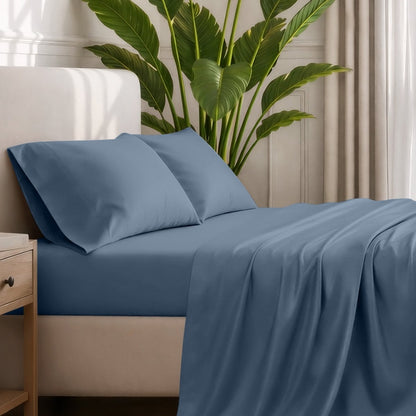 Ultra-soft sheets and pillowcases on a bed with a plant in the background
