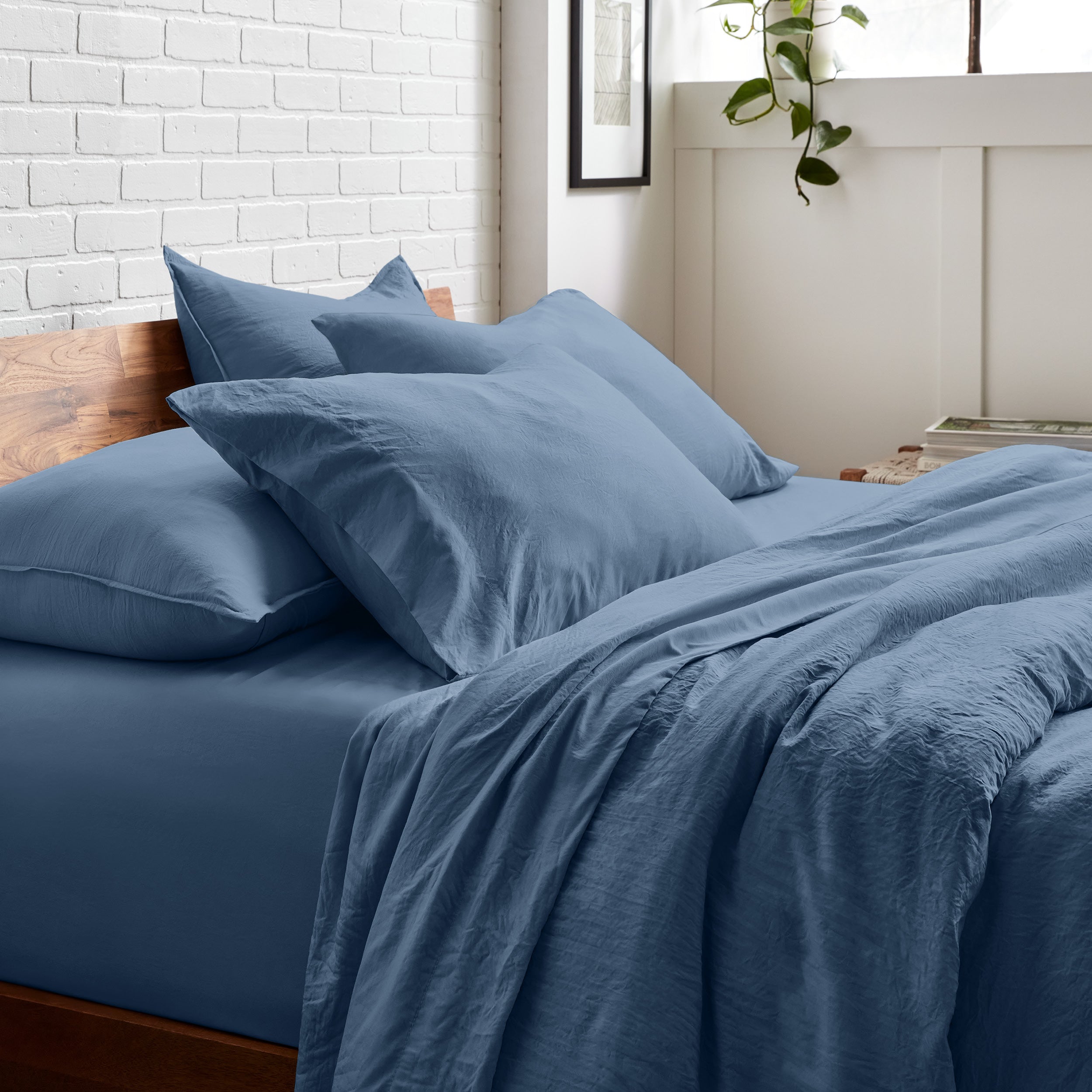 A side view of a bed made with washed sheets and duvet set