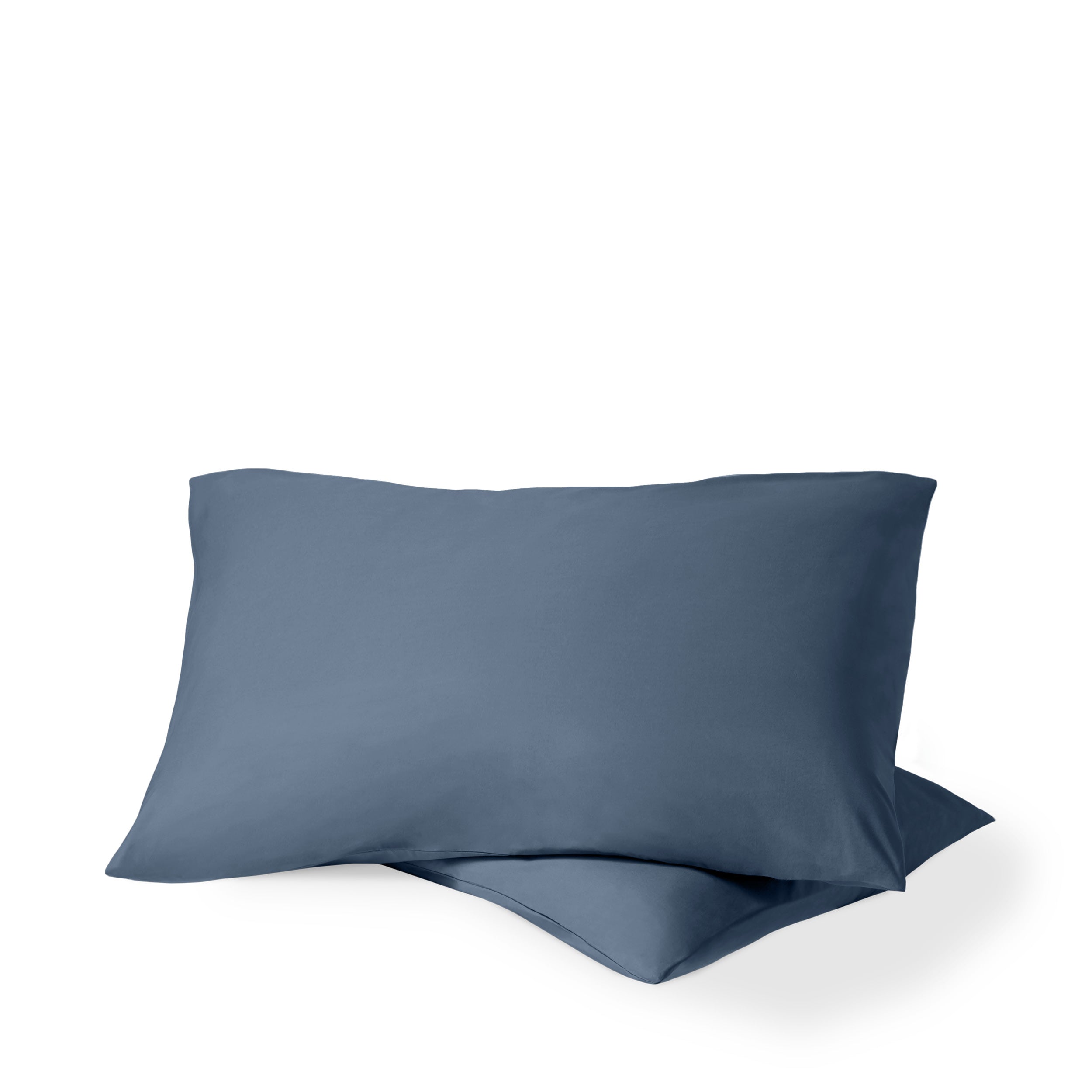 Two pillows with percale pillowcases on them