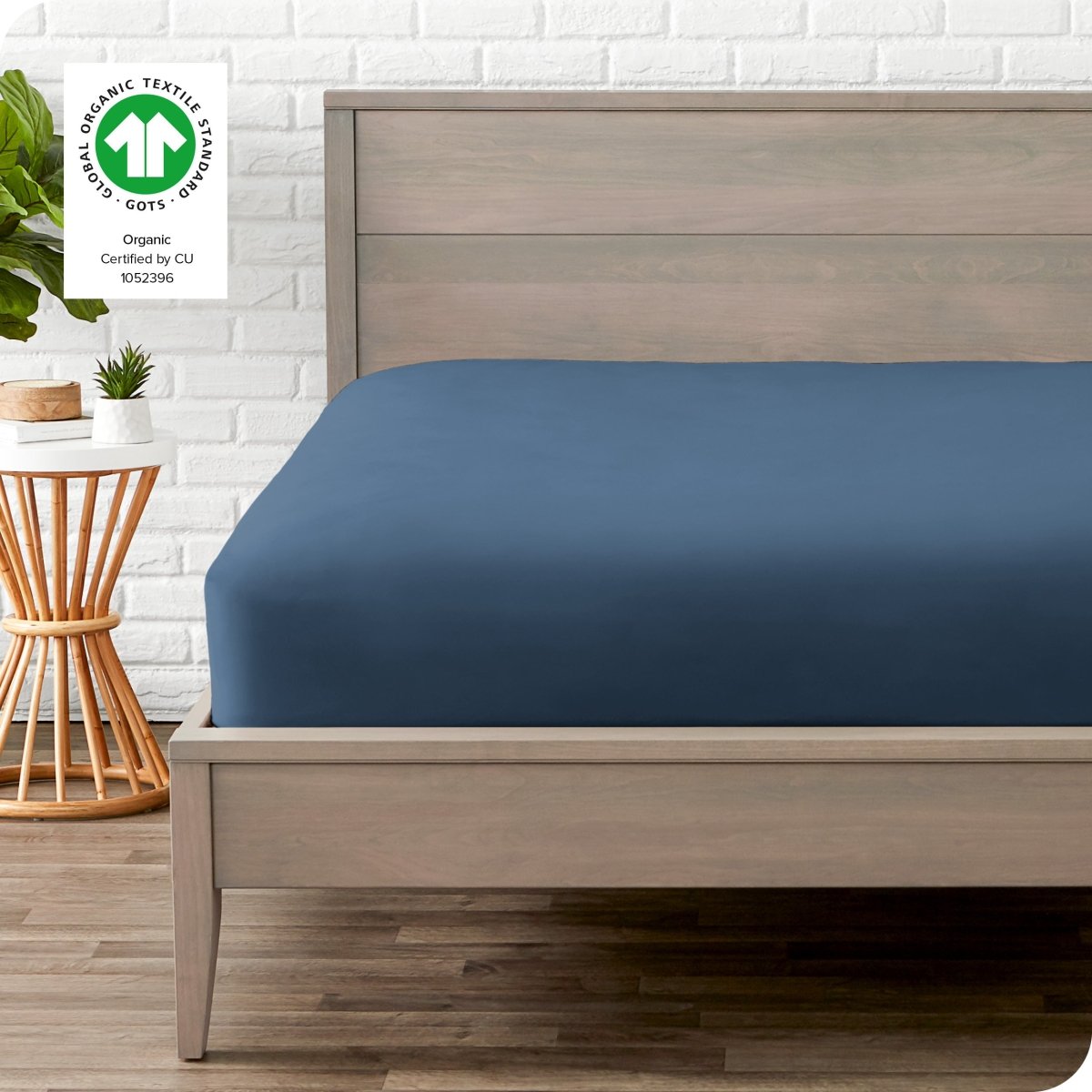 Modern wood bed frame with a sateen fitted sheet on the mattress