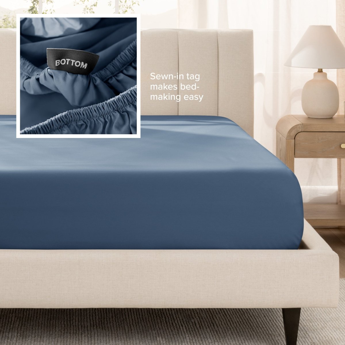 Sateen fitted sheet on a bed with a close-up of a sewn-in tag, set in a bedroom.