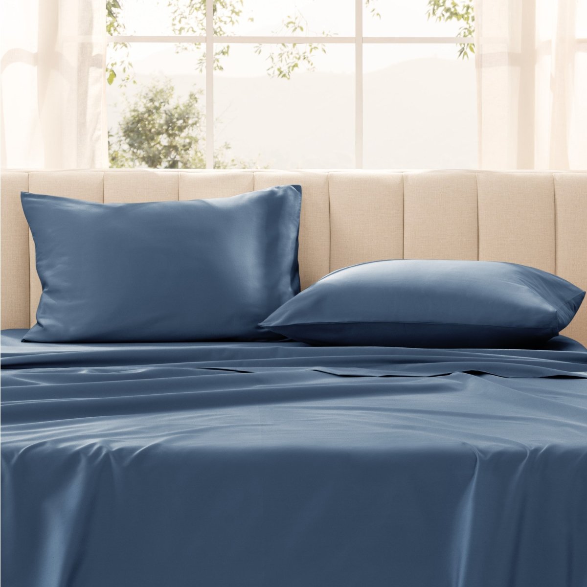 Pillows on a bed with in a bright room.