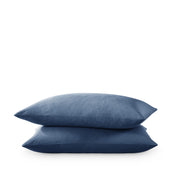 Two pillows stacked on a white background