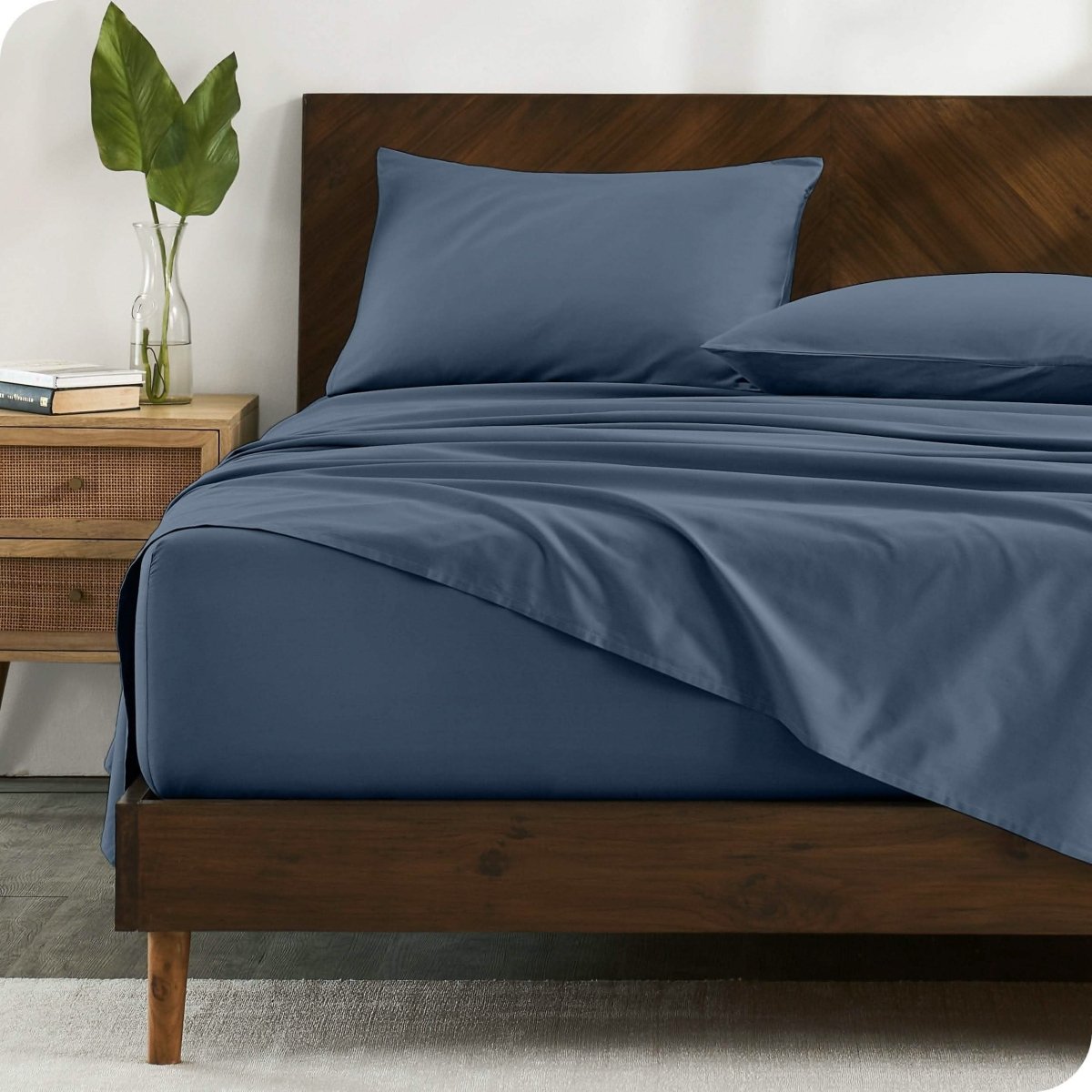 A bed made with organic cotton sateen sheets