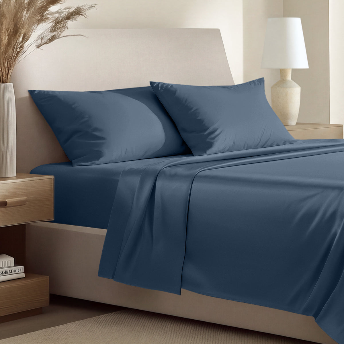 Sateen bedding set including a fitted sheet and two matching pillowcases on a bed.