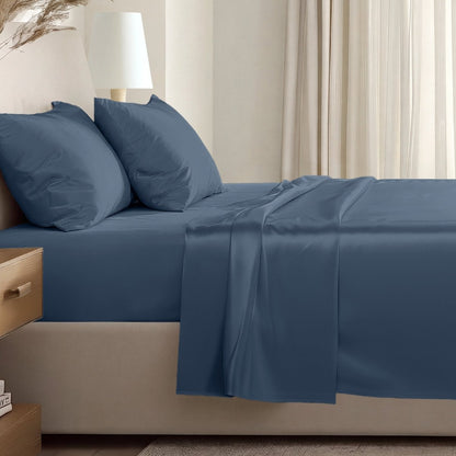 Sateen sheet set on a bed in a softly lit bedroom.