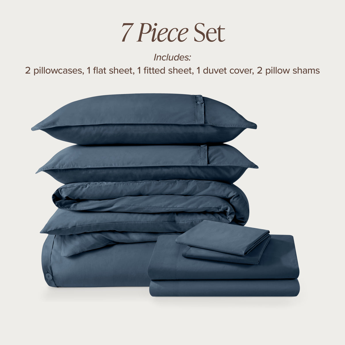 7-piece percale bedding set with pillowcases, flat sheet, fitted sheet, duvet cover, and pillow shams on a light background.