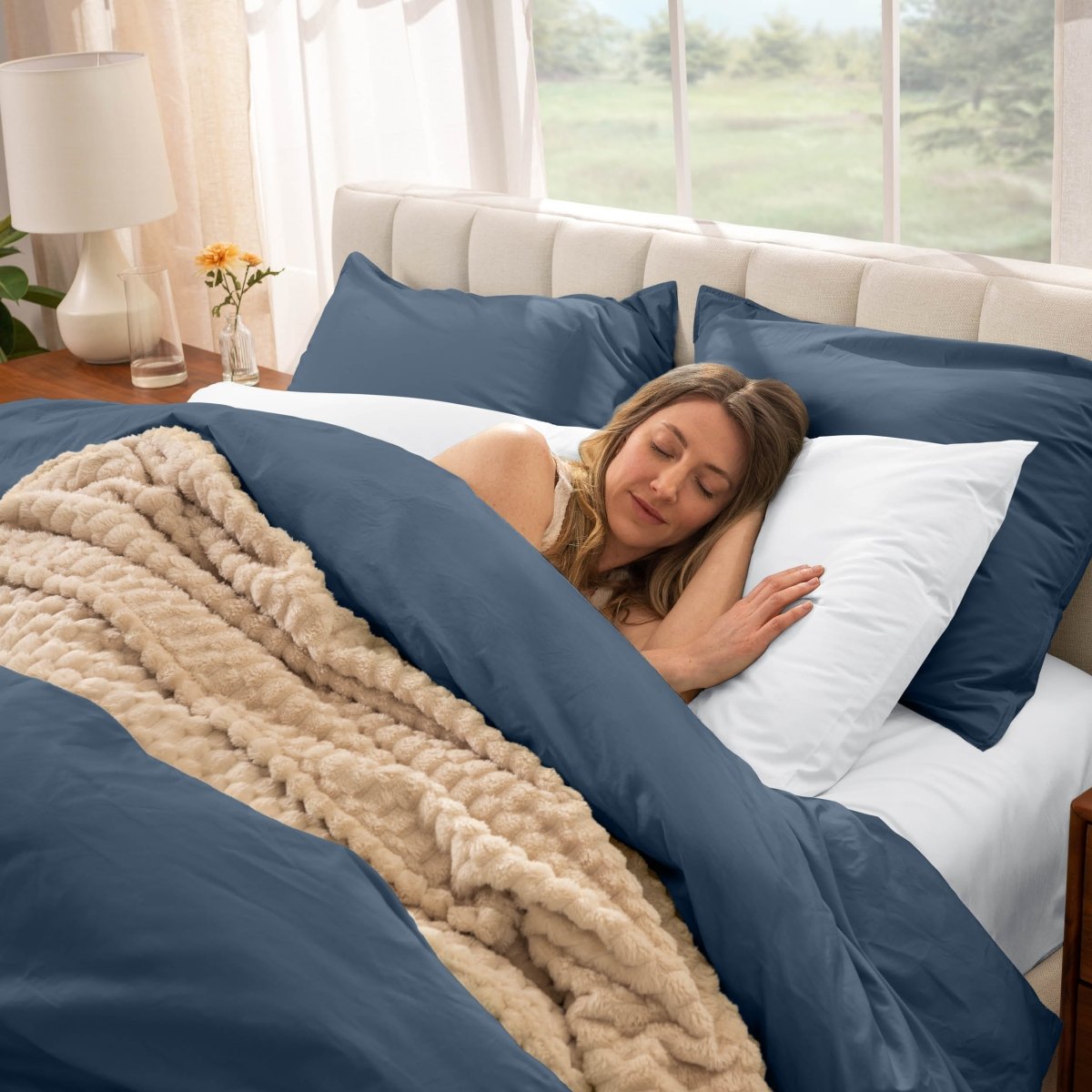 Woman sleeping in a bed with percale bedding
