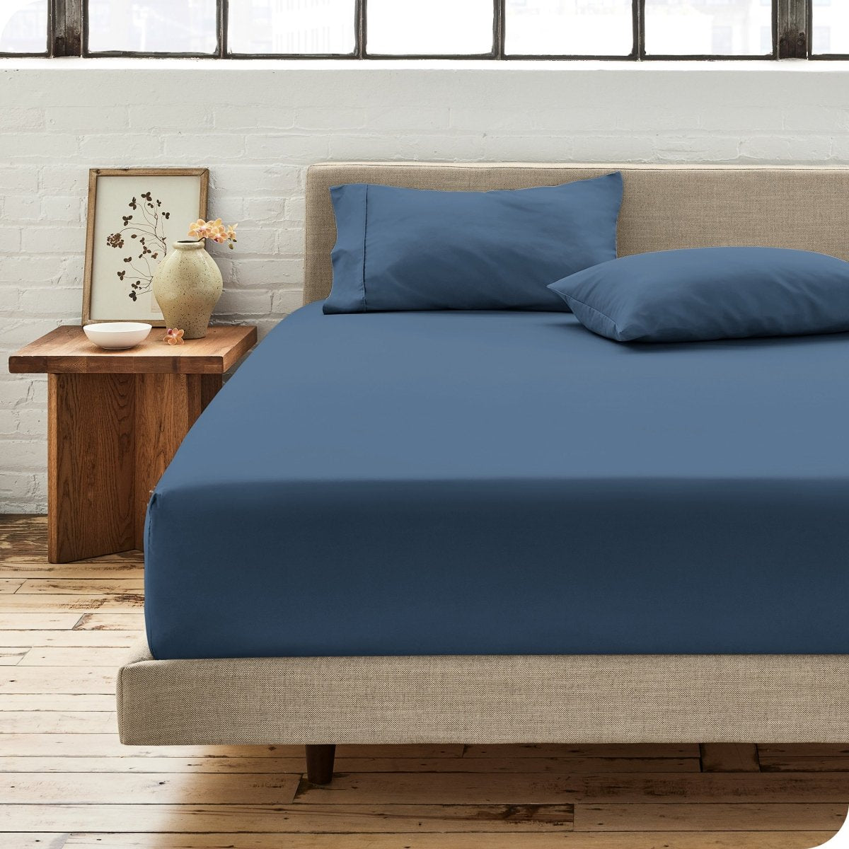 Modern bedroom with bed showing percale fitted sheet
