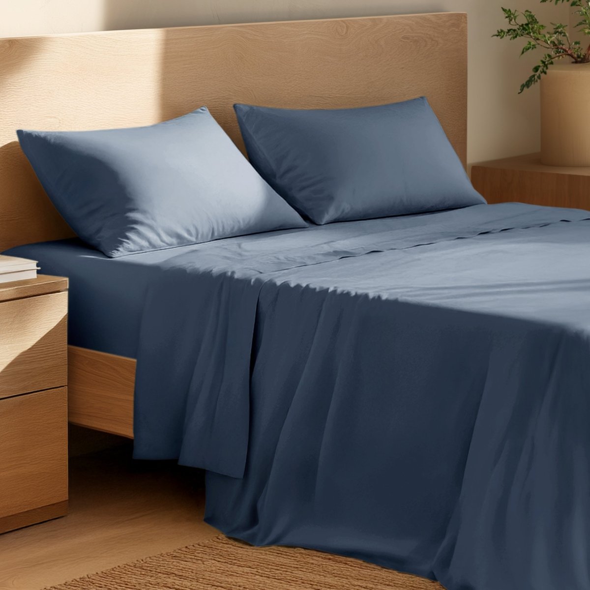 Bed with percale bedding and wooden headboard in a bedroom setting