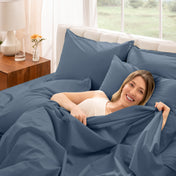 A woman is lying on a bed make with percale sheets and pillowcases