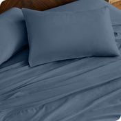 Close up of percale pillowcases and sheets on a bed