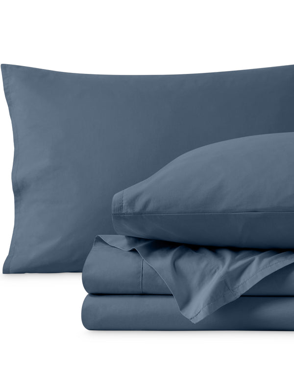 Percale sheets folded and matching pillowcases with pillows in them