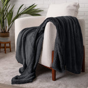 Blanket draped over a chair in a cozy living room setting.