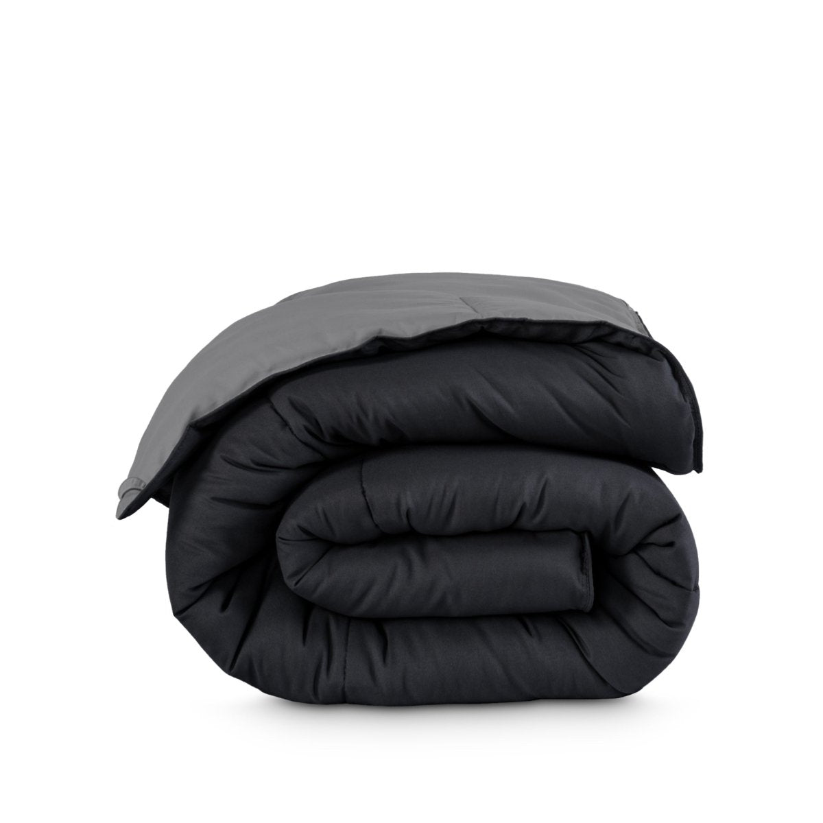 Folded reversible comforter on a white background