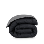 Folded reversible comforter on a white background