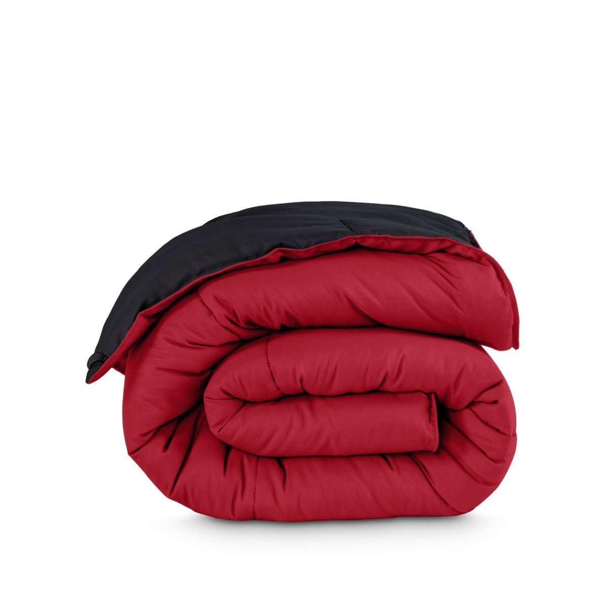 Folded reversible comforter on a white background