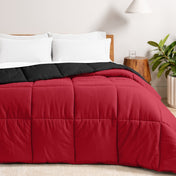 Bed with reversible comforter and white pillows in a bedroom setting