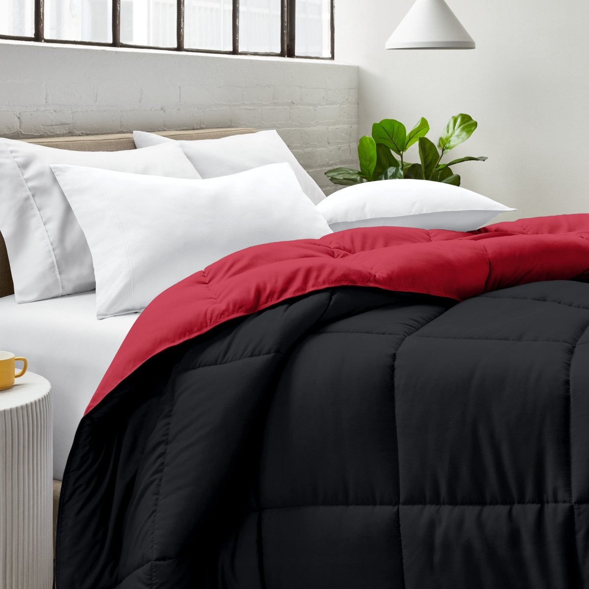 Bed with comforter and white pillows in a bright bedroom setting.