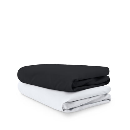Stack of folded crib sheets on a white background