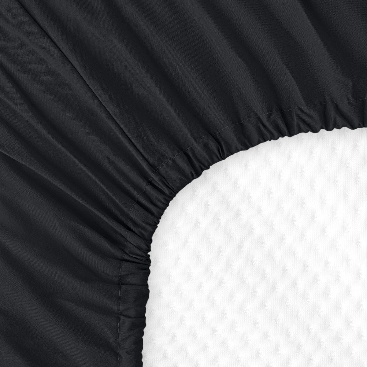 The back of a crib mattress with a fitted sheet on it