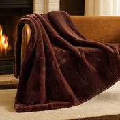 Blanket draped over a chair in front of a fireplace