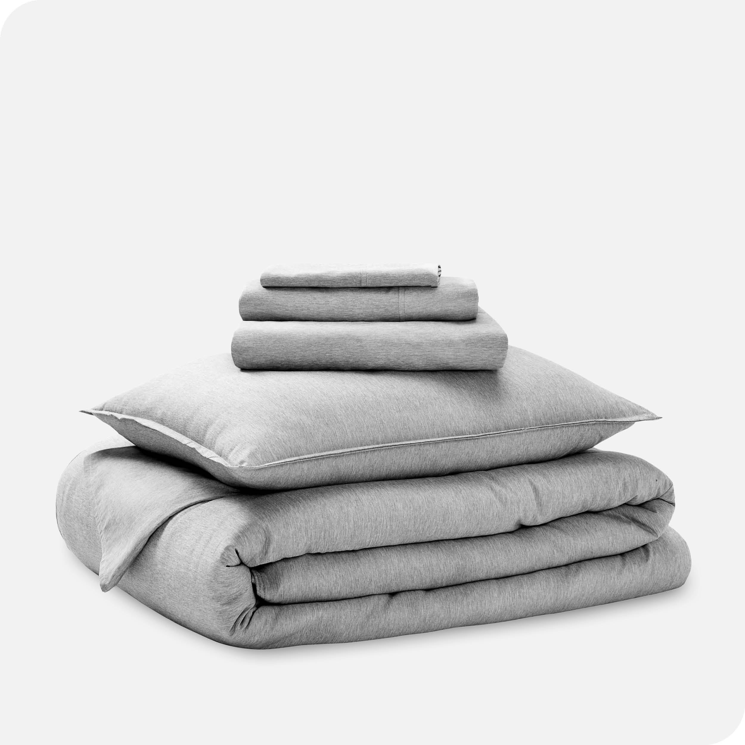 A heathered bedding set folded and stacked.