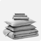 A heathered bedding set folded and stacked.