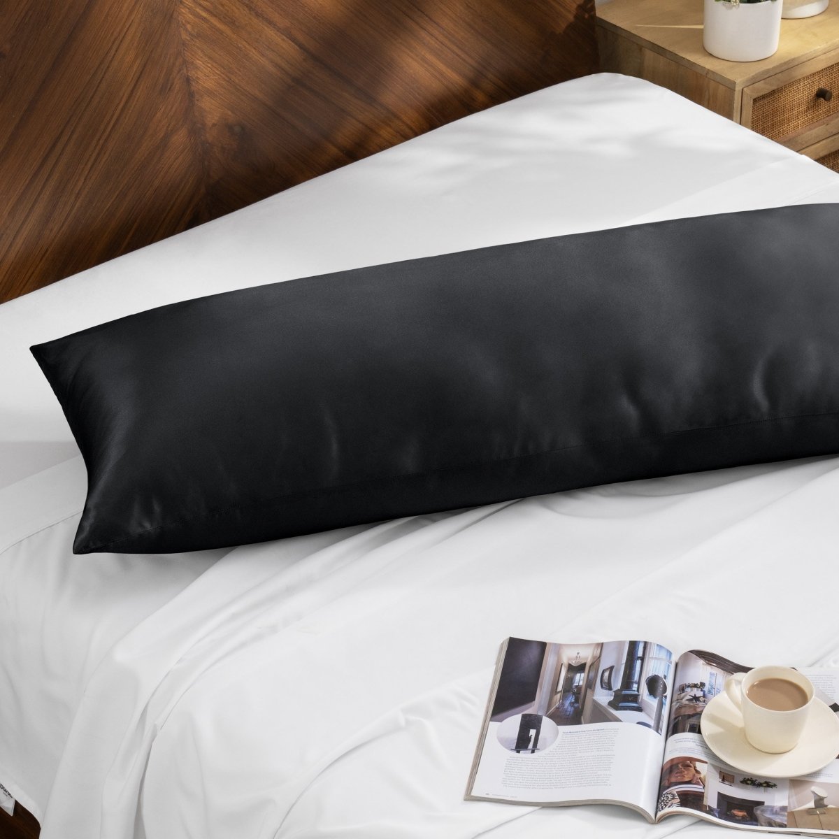 Bamboo pillow on a bed with a magazine and cup of coffee on a wooden nightstand.