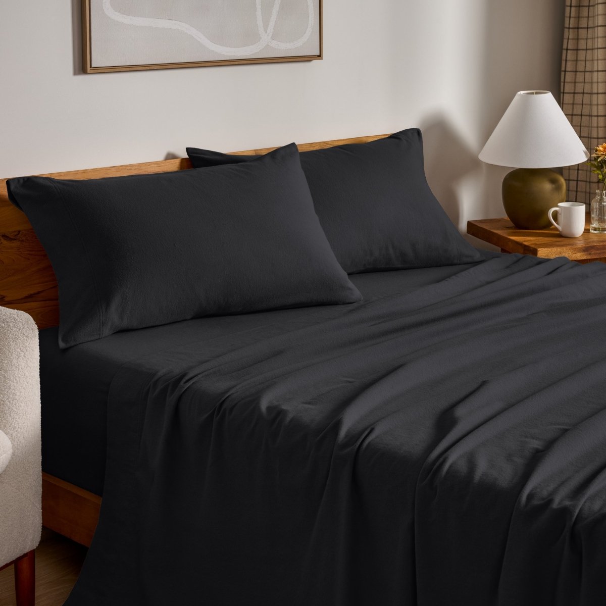 Flannel bed sheets and pillowcases on a bed in a bedroom setting.