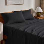 Flannel bed sheets and pillowcases on a bed in a bedroom setting.