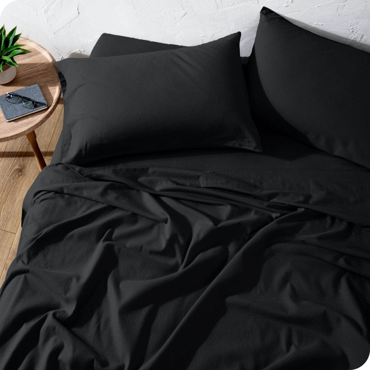 A high front view of a modern bed with a flannel sheet set on it