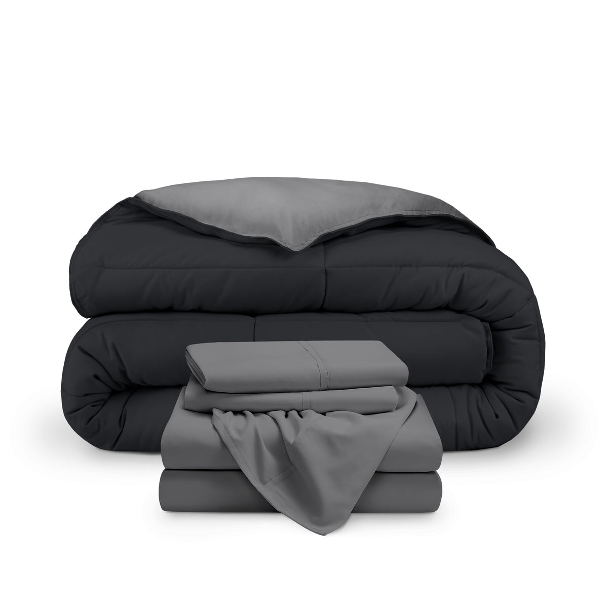 A reversible microfiber comforter and a coordinating sheet set folded and stacked