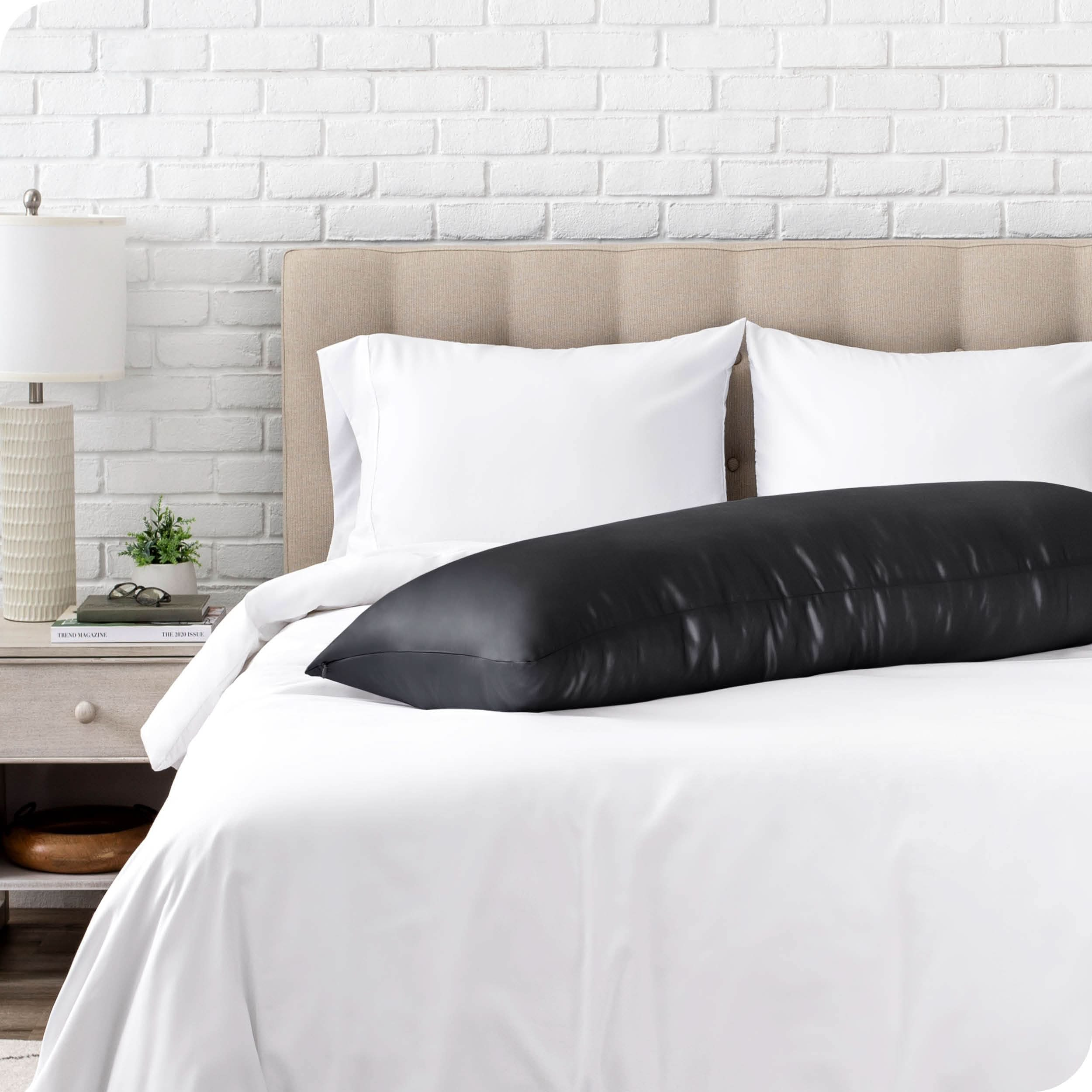 A silk body pillowcase on a pillow resting on a bed