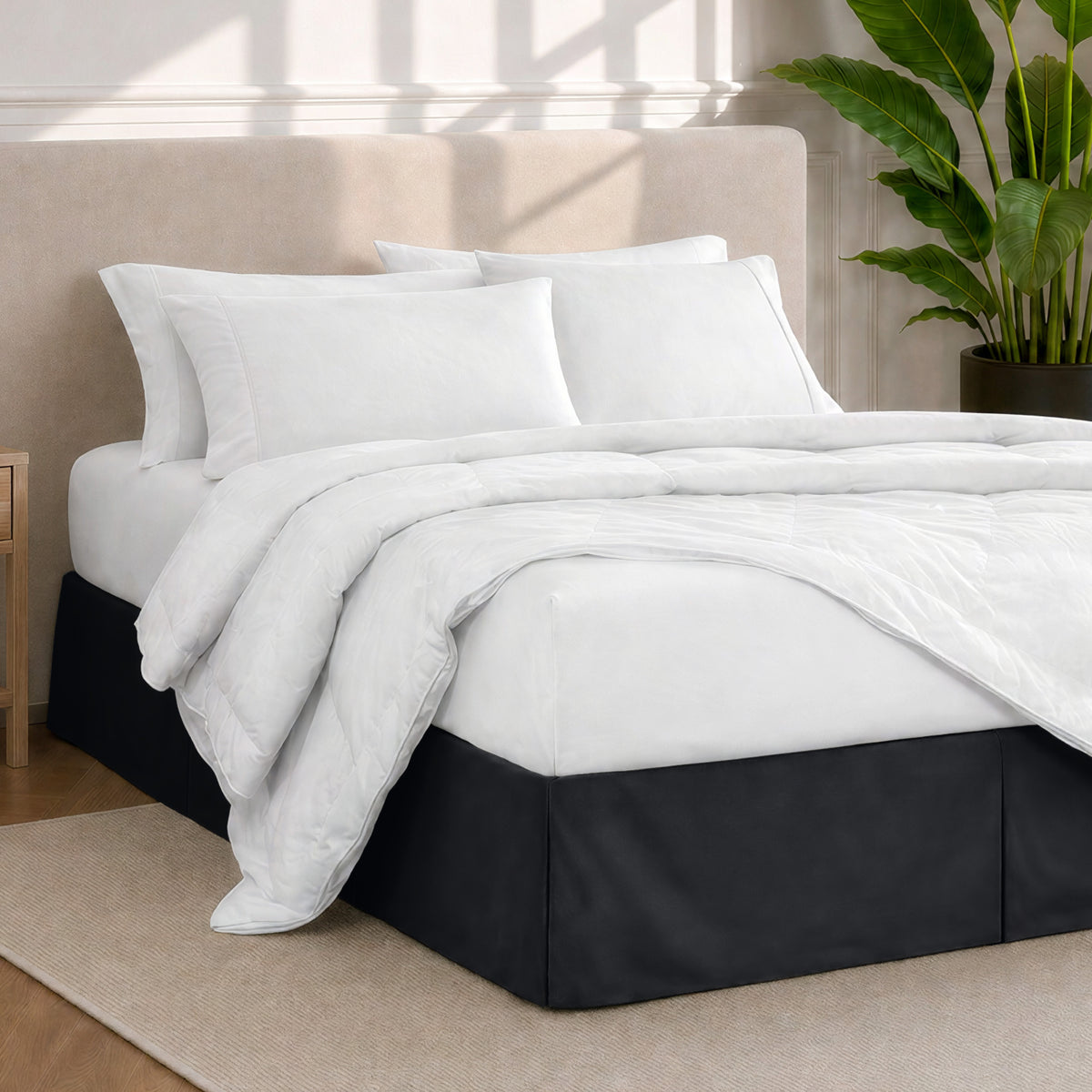A modern bedroom with a bed skirt, comforter and sheets on the bed